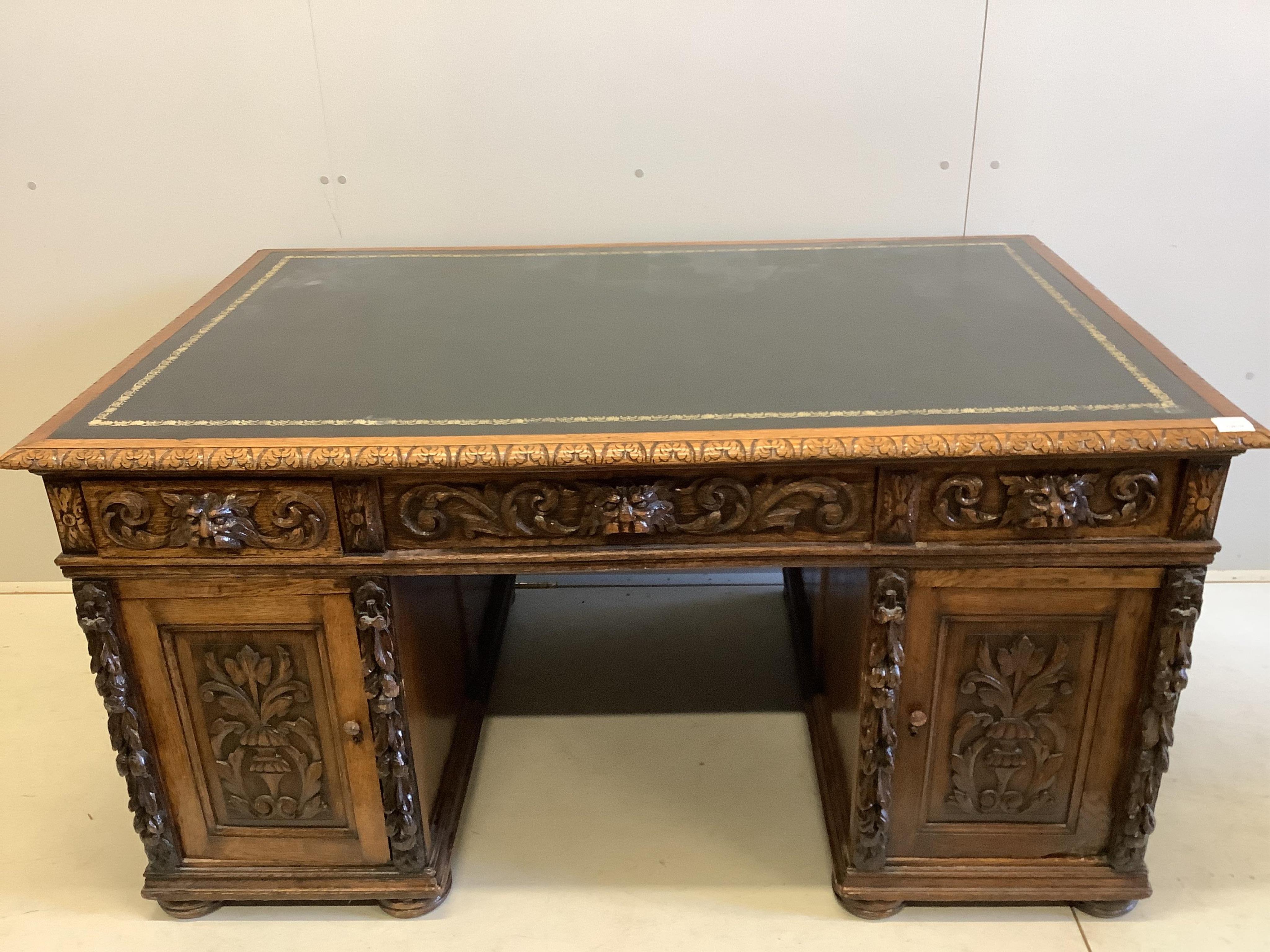 A Victorian carved oak pedestal desk, width 148cm, depth 92cm, height 78cm. Condition - good